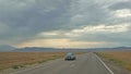Highway leading to Almaty during cloudy weather. Landscapes along the way.