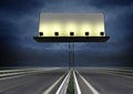 Highway with lighted blank billboard and evening sky Royalty Free Stock Photo