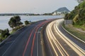 Highway lightstreams along Takitimu Drive at dusk looking north