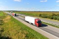 Highway with Lots of semi-trailer trucks . Big lorry traffic on the road. Truck driving along on roadway overtakes another truck.