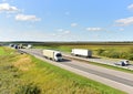 Highway with Lots of semi-trailer trucks . Big lorry traffic on the road. Truck driving along on roadway overtakes another truck.