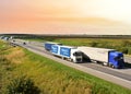 Highway with Lots of semi-trailer trucks . Big lorry traffic on the road. Truck driving along on roadway overtakes another truck.