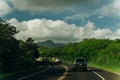 Highway through a lush tropical forest in kauai, hawaii - may 2023 Royalty Free Stock Photo