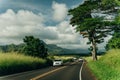 Highway through a lush tropical forest in kauai, hawaii - may 2023 Royalty Free Stock Photo