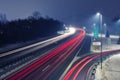 Highway at night with bright trails of light from incoming and outgoing traffic Royalty Free Stock Photo