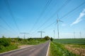 Highway, power transmission lines and wind energy plants Royalty Free Stock Photo