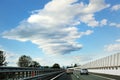 Highway road, cars, guardrail, sky and clouds