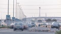 Highway roads with traffic timelapse in a big city from Ajman to Dubai before sunset. Transportation concept.