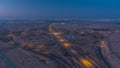 Highway roads with traffic night to day timelapse in a big city from Ajman to Dubai before sunrise. Transportation
