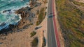 Highway running ocean coast summer day aerial view. Foamy ocean waves crashing Royalty Free Stock Photo