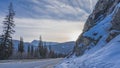 The highway runs along a steep snow-covered mountain slope