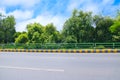 Highway runs through trees green belt in Pakistan.