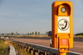 Highway Safety: Orange SOS Calling Box on German Highway amidst Blurry Car Lights, German Text Translation: SOS, emergency call, Royalty Free Stock Photo