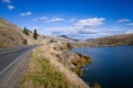 Highway skirting a scenic mountain lake