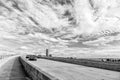 Highway with skyscrapers on blue cloudy sky