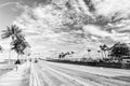 Highway with skyscrapers on blue cloudy sky