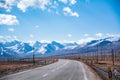 Highway by the snow mountain in high altitude region Royalty Free Stock Photo