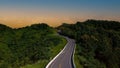 The highway stairs to the sunset sky scene of road trough with green nature forest as the natural landscape Royalty Free Stock Photo