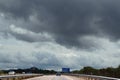 Highway and storm clouds Royalty Free Stock Photo