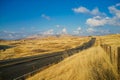 Highway with Tall Yellow Grass and Blue Sky