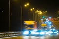 Highway traffic cars at night blured. Cars moving on road on bridge evening blurry. Royalty Free Stock Photo