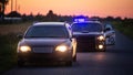 Highway Traffic Patrol Car Pulls over Vehicle Check on Empty Road. Police Officer Comes out of Car Royalty Free Stock Photo