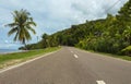 Highway on tropical island. Coastal road in the afternoon. Empty road by the seaside. Royalty Free Stock Photo