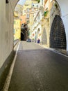 Highway tunnel with views of colorful buildings at the end opening of Amalfi Coast