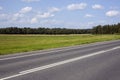 A highway under blue sky with clouds of white