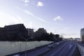 Highway view from above with speeding cars and apartment buildings in the background