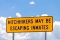 Highway warning sign about hitchhikers that might be escaping in Royalty Free Stock Photo