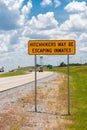 Highway warning sign about hitchhikers that might escaping inmates