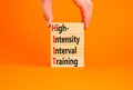 HIIT high-intensity interval training symbol. Concept words HIIT high-intensity interval training on blocks on a beautiful orange Royalty Free Stock Photo