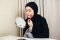 Hijab cosmetic using brush on face asian women. Royalty Free Stock Photo