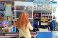 hijab girl Customer in front of cashier to pay in Indomaret (Local Indonesia minimarket )