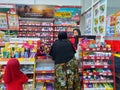 hijab girl Customer in front of cashier to pay inside Alfamart (Local Indonesia minimarket retail store