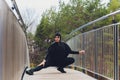 Hijab girl exercising on walkway bridge in early morning. Muslim woman wearing sports clothes doing stretching workout Royalty Free Stock Photo