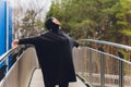 Hijab girl exercising on walkway bridge in early morning. Muslim woman wearing sports clothes doing stretching workout Royalty Free Stock Photo