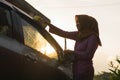 Hijab Woman car washing with yellow sponge  washing her car  in front of the house Royalty Free Stock Photo