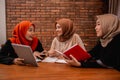 Hijab women chatting with friends about university assignments
