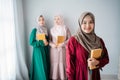 Hijab women smiling hold holy book of Al-quran