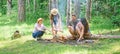 Hike barbecue. Friends enjoy weekend barbecue in forest. Company friends picnic or barbecue roasting food near bonfire Royalty Free Stock Photo