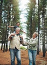 Hike, nature and children with senior foster parents and their adopted son walking on a sand path through the tress