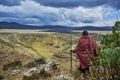 Traditional Masai looks over crater rim moutain