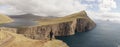 Hike to the Traelanipa Slave Cliff near Leitisvatn Lake with steep drops into the ocean on the Faroe Islands, Denmark. Royalty Free Stock Photo