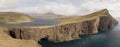 Hike to the Traelanipa Slave Cliff near Leitisvatn Lake with steep drops into the ocean on the Faroe Islands, Denmark. Royalty Free Stock Photo