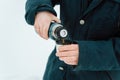 Hike, travel, tourism, warm drink in cold weather concept. Close-up of man in winter jacket pours hot tea from thermos into mug Royalty Free Stock Photo