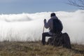 Hiker above the clouds