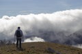 Hiker above the clouds