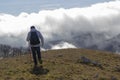 Hiker above the clouds